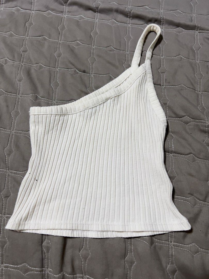 White One-Shoulder Ribbed Tank Top (Category: Sleeveless) located in Bacolod City. Submitted by strawberrymochi1201 (Listing ID 1471258722, Image 2). Description: - Color: White - Design: Chic one-shoulder strap with a trendy crop length - Material: Stretchy, ribbed knit fabric that hugs your curves - Styling: Pairs effortlessly with high-waisted jeans or skirts - Condition: Brand new / Excellent - Perfect for: Casual outings, daily wear, and str