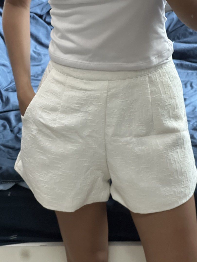 White textured high-waisted shorts with pockets (Category: Shorts) located in Quezon City. Submitted by valeriorac74670 (Listing ID 1471174568, Image 3). Description: - Color: White with a subtle woven geometric pattern - Fit: High-waisted with front pleats and side pockets - Style: Clean tailoring for a crisp, polished look - Condition: Worn once, still in great shape, clean and ready to wear.