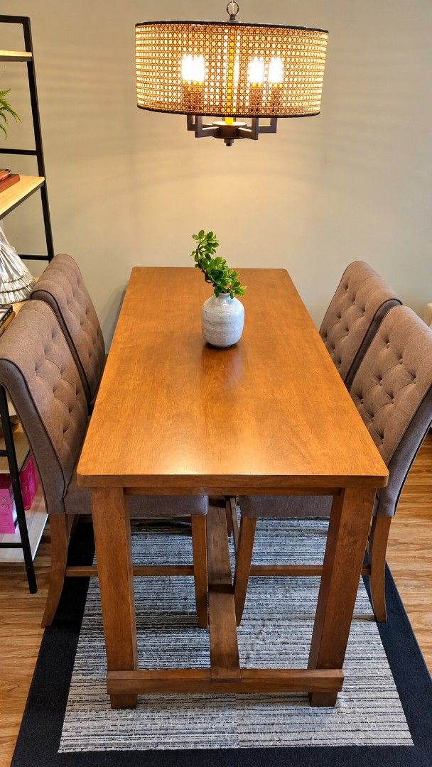 Wooden Counter Height Dining Table with 4 Chairs (Category: Tables & Sets) located in Manila. Submitted by lacsinage79898 (Listing ID 1471173005, Image 3). Description: - Complete Dining Set: Includes 1 solid wood counter-height table and 4 matching tufted upholstered chairs in a rich brown finish. - Bonus Decor: Comes with a stylish decorative ceramic vase and plant centerpiece. - Sturdy & Comfortable: Built with a strong wooden frame and conven
