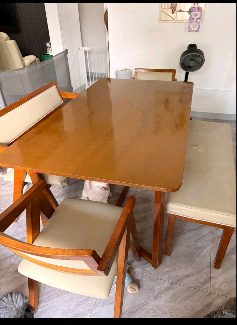 Wooden dining table set with chairs and bench (Category: Tables & Sets) located in Pasay City. Submitted by enajm (Listing ID 1471203569, Image 3). Description: - Wooden dining table set with matching bench and chairs - Warm brown tabletop with sturdy wooden frames and stylish angled legs - Cream faux leather cushions on all seats (Note: one cushion has a noticeable indentation mark) - Perfect size for cozy family meals and gatherings - Self-coll