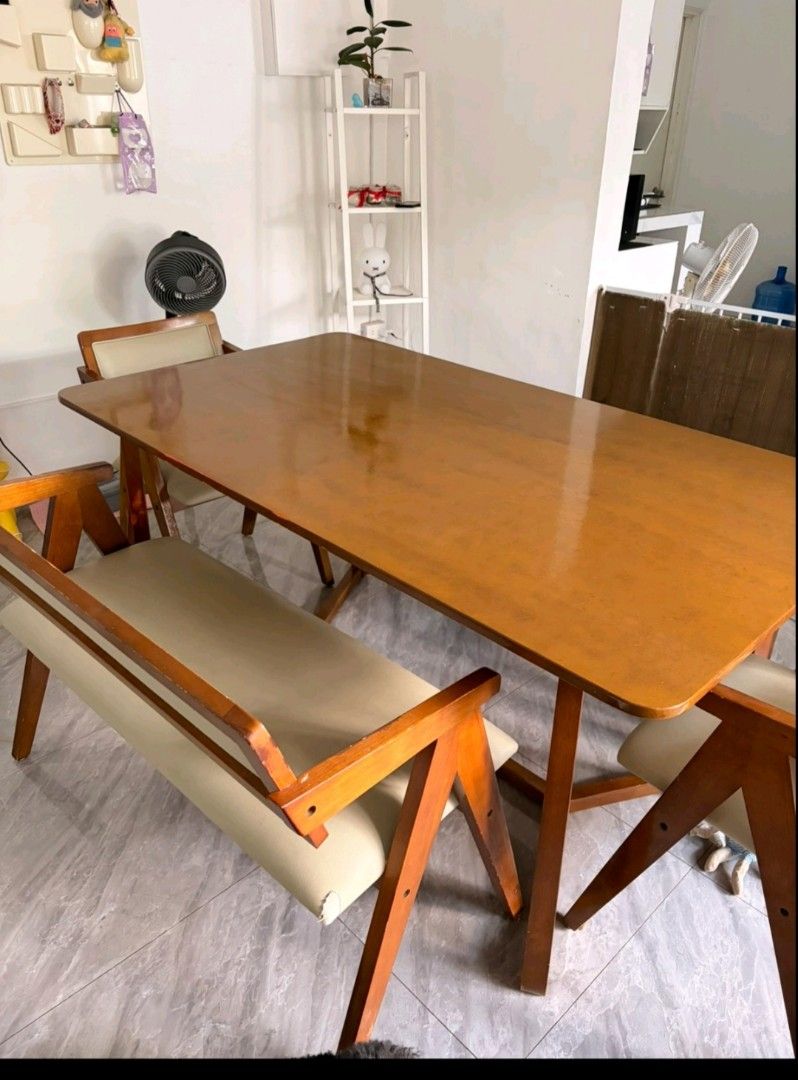 Wooden dining table set with chairs and bench (Category: Tables & Sets) located in Pasay City. Submitted by enajm (Listing ID 1471203569, Image 2). Description: - Wooden dining table set with matching bench and chairs - Warm brown tabletop with sturdy wooden frames and stylish angled legs - Cream faux leather cushions on all seats (Note: one cushion has a noticeable indentation mark) - Perfect size for cozy family meals and gatherings - Self-coll