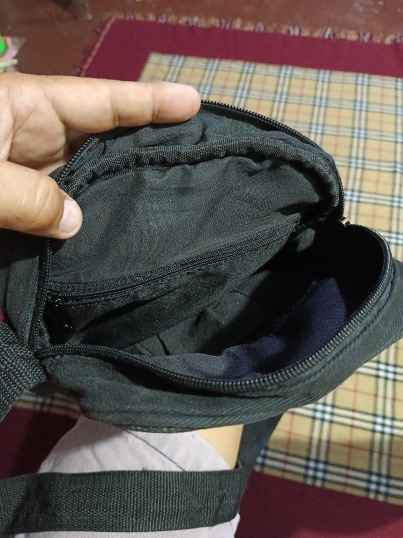 Xlarge Plaid Crossbody Bag (Category: Activewear) located in General Santos City (Dadiangas). Submitted by freehorse.5f2a61 (Listing ID 1471226332, Image 3). Description: - Brand: Xlarge - Design: Black and grey plaid sling bag - Strap: Adjustable black strap with durable metal hardware - Pockets: Front zipped pocket, main compartment, and an inner zip pocket - Storage: Ideal size for daily essentials like phone, keys, and wallet - Condition: Goo