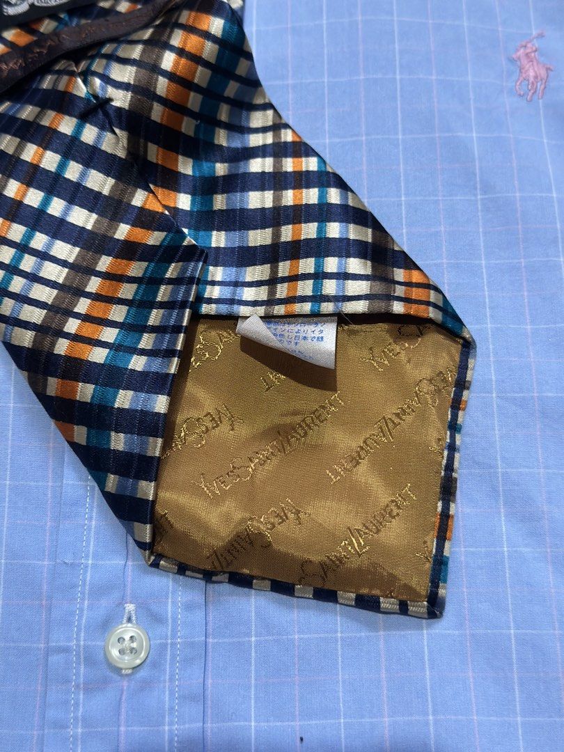 Yves Saint Laurent Plaid Silk Tie (Category: Ties) located in Daet. Submitted by thrifthings2018 (Listing ID 1471195478, Image 3). Description: - Brand: Yves Saint Laurent (YSL) - Material: 100% High-quality Silk - Design: Vibrant plaid check in navy blue, orange, teal, and cream - Details: Signature YSL branded lining on the back, classic pointed blade shape - Condition: Excellent pre-owned condition - Styling: Ideal for formal wear, business me