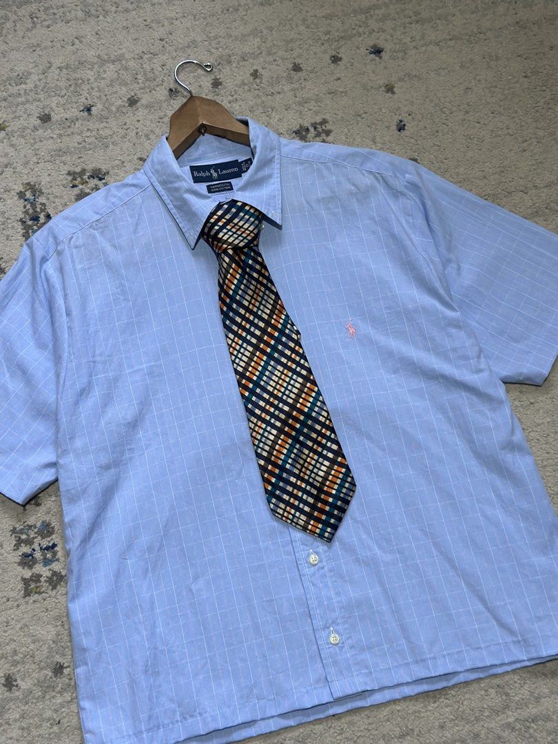 Yves Saint Laurent Plaid Silk Tie (Category: Ties) located in Daet. Submitted by thrifthings2018 (Listing ID 1471195478, Image 1). Description: - Brand: Yves Saint Laurent (YSL) - Material: 100% High-quality Silk - Design: Vibrant plaid check in navy blue, orange, teal, and cream - Details: Signature YSL branded lining on the back, classic pointed blade shape - Condition: Excellent pre-owned condition - Styling: Ideal for formal wear, business me