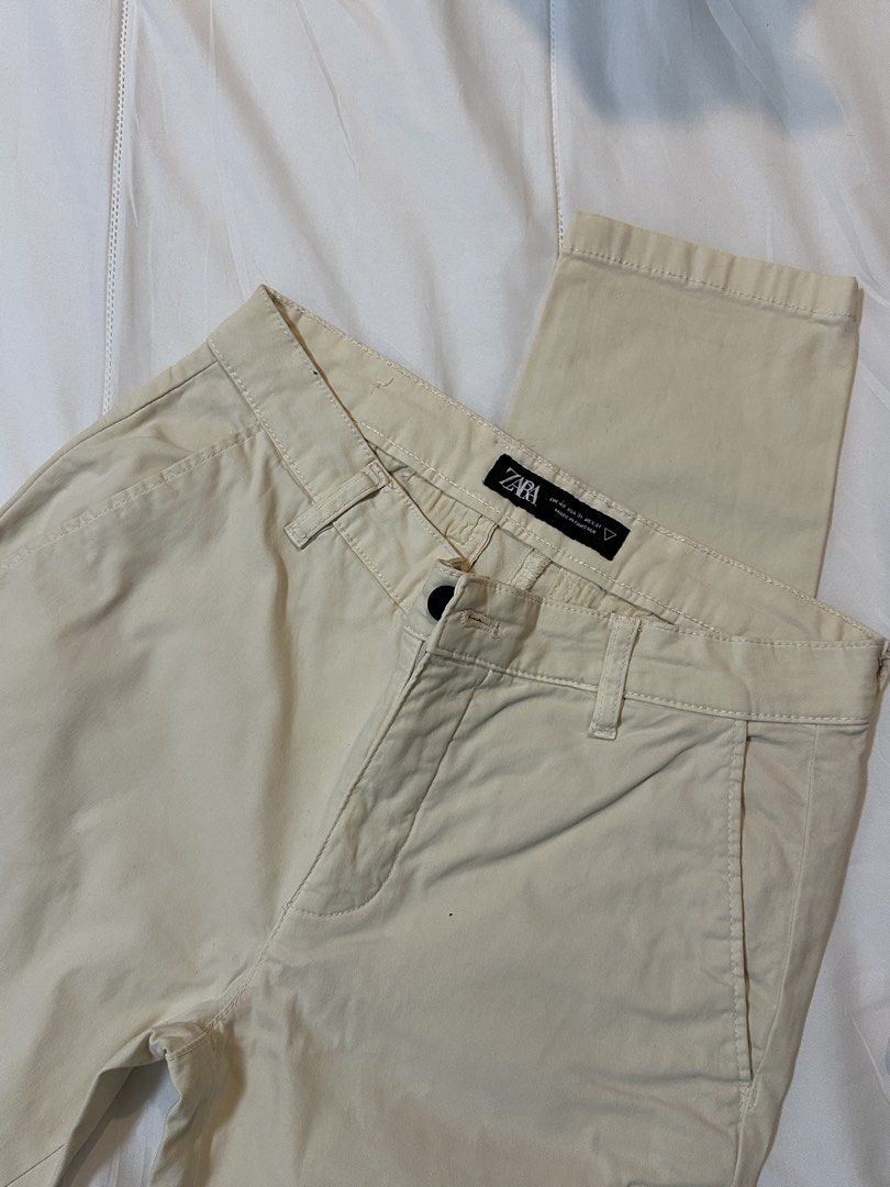 Zara Beige Chino Trousers (Category: Trousers) located in Bulacan. Submitted by juyeonloey (Listing ID 1471263079, Image 1). Description: - Brand: Zara - Color: Versatile beige - Fit: Standard fit - Closure: Button closure - Pockets: Front slash pockets and dual back welt pockets with button fastening - Details: Small denim wear logo tag on the right rear pocket - Origin: Made in Pakistan - Style: Great for casual or smart-casual outfits.