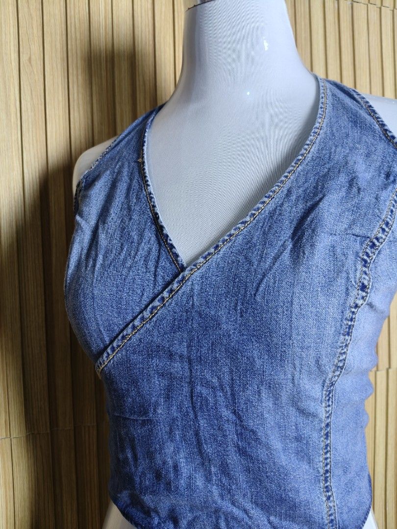 Zara Denim Wrap Halter Crop Top Size L (Category: Sleeveless) located in Taguig. Submitted by ashie_clothing (Listing ID 1471238052, Image 2). Description: - Brand: Zara - Condition: Brand new with original tags attached - Size: L - Color/Material: Blue denim with contrast yellow stitching - Style: Wrap halter top with V-neck front - Closure: Self-tie ribbon bow in the back.