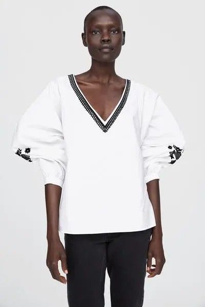 Zara Embroidered V-Neck White Blouse (Category: Blouses) located in Cavite. Submitted by frombellas (Listing ID 1471201780, Image 1). Description: 📍 Sadly, due to storage there's small patches seen on the top. - Brand: Zara - Color: White with black geometric embroidery - Material: Lightweight cotton, relaxed fit - Design: V-neck and dramatic bishop sleeves with button cuffs - Style: Casual wardrobe staple, perfect with jeans or trousers.