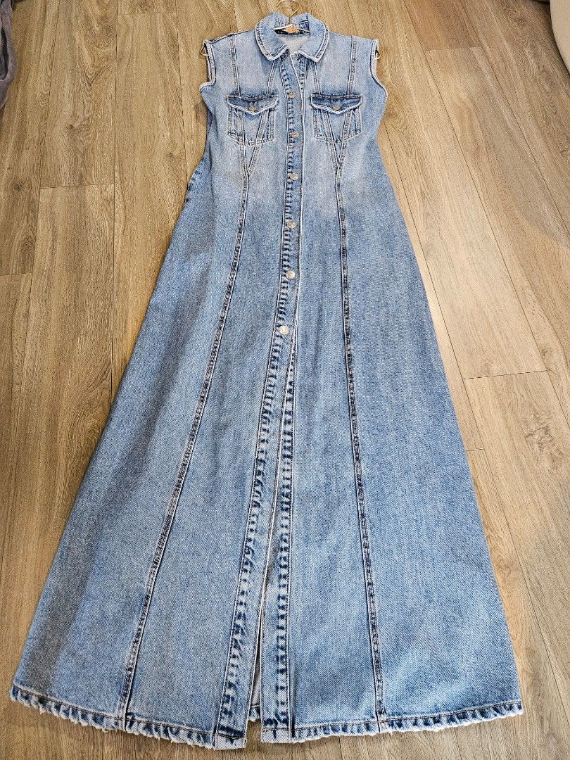 Zara Long Denim Button-Down Maxi Dress (Category: Dresses) located in Davao. Submitted by Tineeee. (Listing ID 1471167056, Image 1). Description: - Style: Light wash long denim maxi dress - Closure: Full front button placket - Pockets: Two functional chest pockets with flaps - Details: Sleeveless with trendy frayed raw hem along armholes and bottom - Fit: Panel-stitched construction for a flattering flow - Material: Sturdy, durable cotton denim.