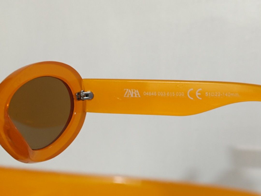 ZARA Orange Oval Sunglasses (Category: Sunglasses & Eyewear) located in Quezon City. Submitted by pumpkinspice08 (Listing ID 1471167340, Image 2). Description: no glasses case. barely used. minor scratches. Bright orange oval sunglasses from Zara. Chunky frames with brown tinted lenses. Fun pop of colour for summer outfits, festivals, or everyday sunny days. Model number 04646 003 615 030 stamped on the arm. Measurements are 51□22-140mm. Clear an