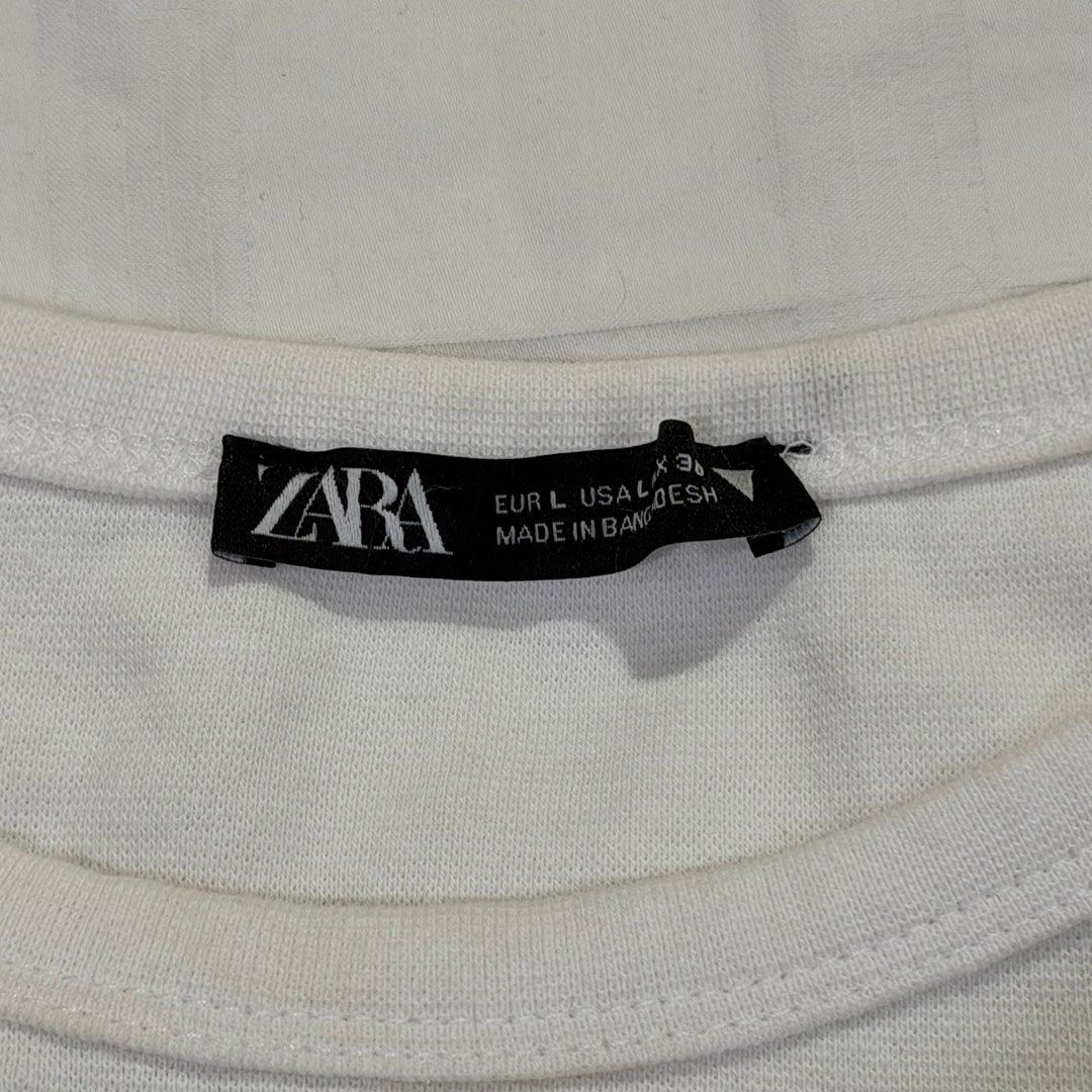 Zara White Crop Top Tee (Category: Shirts) located in Caloocan City. Submitted by preloveditemsbyyana (Listing ID 1471287555, Image 2). Description: - Brand: Zara - Color: White - Style: Short sleeve crop top with round neckline and relaxed fit - Size: L (EUR/USA) - Made in: Bangladesh - Condition: Excellent basic everyday piece, easy to match with high-waisted denim or skirts.