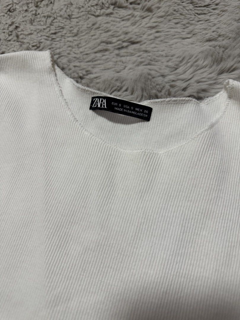 ZARA White Ribbed Tank Top Size S (Category: Sleeveless) located in Calamba. Submitted by cheriiv (Listing ID 1471170940, Image 2). Description: - Brand: ZARA - Size: EUR S / USA S / MEX 26 - Color: White - Material: Soft, stretchy ribbed fabric - Design: Classic crew neckline, sleeveless.