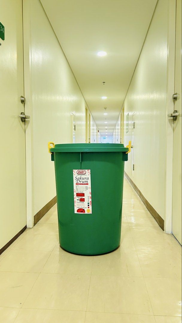 Zooey Sakura Drum Plastic Storage Container Green (Category: Storage Boxes & Baskets) located in Quezon City. Submitted by hazelnutt.922 (Listing ID 1471257241, Image 1). Description: - Brand/Model: Zooey Sakura Drum (Stock No. 950-XL) - Color: Green body with bright yellow locking handles - Material: Durable round plastic - Condition: Clean, excellent for use - Features: Front white sticker label with specs and size details - Best For: Convenien