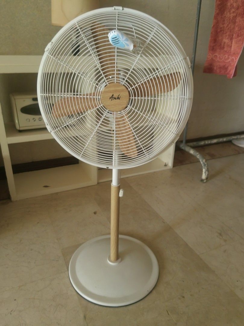 Asahi Wooden Blade Standing Fan (Category: Fans) located in Makati City. Submitted by donald1983 (Listing ID 1471307954, Image 1). Description: - Color: White with chic wood-look blades and pole - Condition: Fully working, blows strong air - Features: Adjustable height, oscillation, and multiple speed settings - Safety: Secure wire safety cage and sturdy round base - Ideal for: Living rooms and bedrooms.