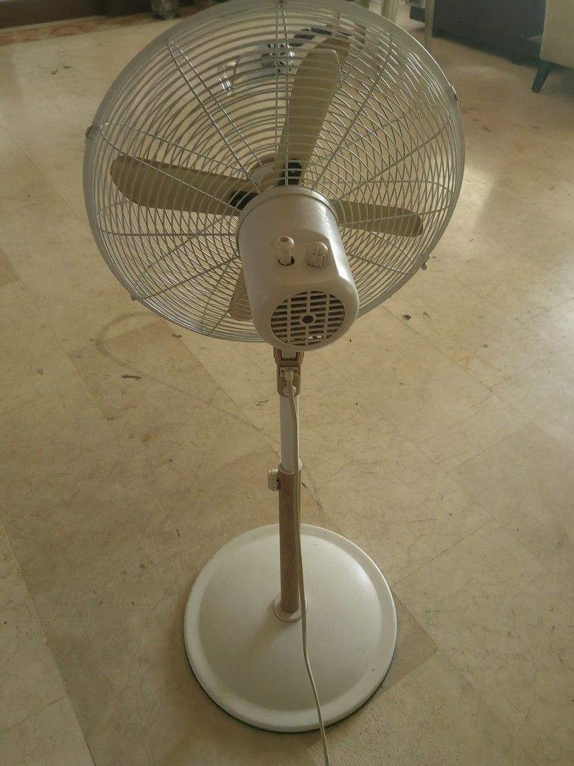 Asahi Wooden Blade Standing Fan (Category: Fans) located in Makati City. Submitted by donald1983 (Listing ID 1471307954, Image 2). Description: - Color: White with chic wood-look blades and pole - Condition: Fully working, blows strong air - Features: Adjustable height, oscillation, and multiple speed settings - Safety: Secure wire safety cage and sturdy round base - Ideal for: Living rooms and bedrooms.