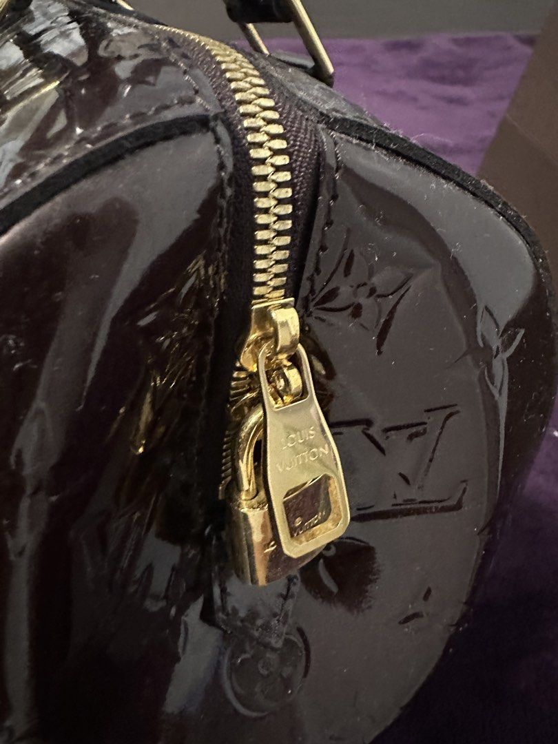 Authentic Louis Vuitton Monogram Vernis Speedy Handbag (Category: Luxury Bags & Wallets) located in Manila. Submitted by pbum168 (Listing ID 1471308682, Image 2). Description: - Authentic Louis Vuitton Alma handbag in stunning Amarante Monogram Vernis leather - Structured bowling silhouette with elegant rolled top handles - Luxurious gold-tone hardware and matching padlock on the zipper - Glossy embossed monogram finish for a timeless look - Incl