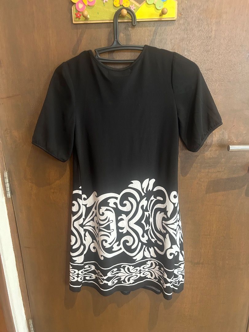 Black and white patterned short sleeve dress (Category: Dresses) located in Quezon City. Submitted by royalturtle.7a28b0 (Listing ID 1471330369, Image 1). Description: - Style: Casual short sleeve mini dress with round neckline - Design: Eye-catching white floral damask pattern on the lower hem and pleated front detail - Fit: Standard sizing, easy pullover style - Comfort: Made from lightweight fabric, ideal for daily wear and weekend outings.