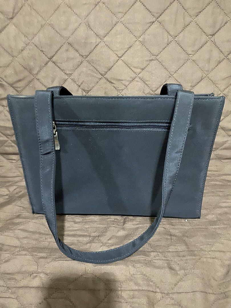 Black Fabric Tote Bag with Shoulder Straps (Category: Tote Bags) located in Manila. Submitted by divinemercy_29 (Listing ID 1471309830, Image 2). Description: - Color: Black - Material: Durable fabric with structured shape that stays upright - Closure: Snap button on middle section - Pockets: Multiple interior compartments, 1 interior zip pocket, and 1 exterior back zip pocket - Straps: Dual secure shoulder straps - Condition: Clean exterior with
