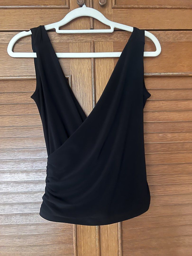 Black sleeveless wrap top with deep V-neck (Category: Sleeveless) located in Manila. Submitted by cheddarph (Listing ID 1471366583, Image 1). Description: .