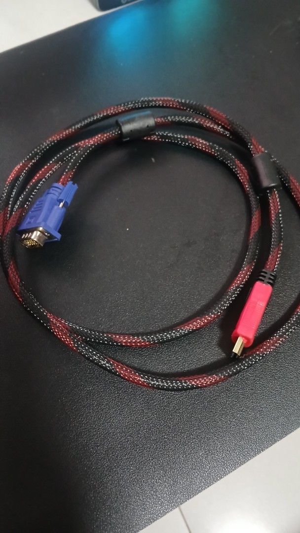 Braided HDMI to VGA Cable Red Black (Category: Cables & Adaptors) located in Pasig City. Submitted by mfumi_official (Listing ID 1471319732, Image 2). Description: - Type: HDMI to VGA display cable - Design: Red and black braided mesh sleeve (no fraying) - Connectors: Gold-plated with protective housing - Interference Reduction: Built-in ferrite cores for stable signal - Condition: Tested, fully operational, and clean connectors - Length: Standar