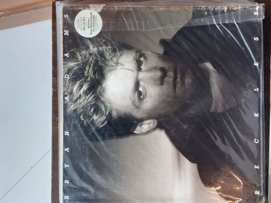 Bryan Adams Reckless Vinyl LP Album Record (Category: Vinyls) located in Quezon City. Submitted by safefish_95f205 (Listing ID 1471319862, Image 1). Description: - Artist & Album: Bryan Adams - Reckless LP - Condition: Clean record, ready for spinning on your turntable - Packaging: Original sleeve with protective plastic wrap still intact - Hits Included: Heaven, Run To You, and Summer of '69 - Details: Tracklist visible on the back cover.