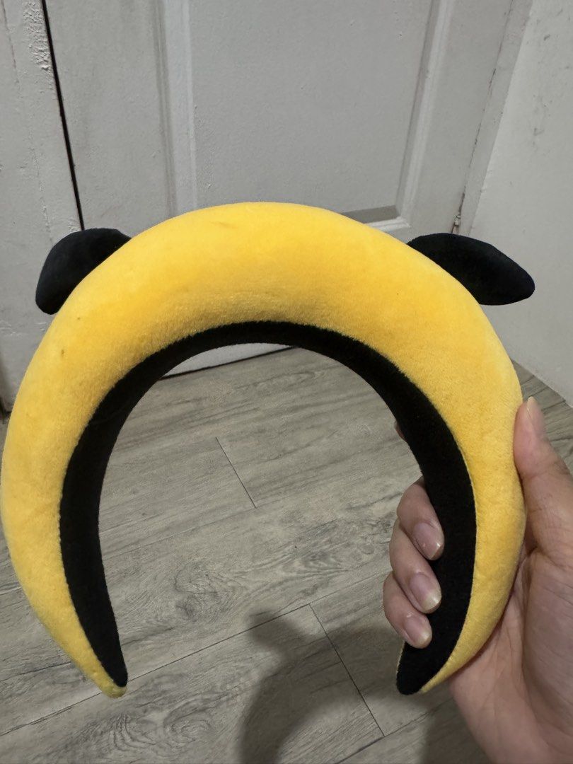 BT21 Chimmy Character Plush Headband (Category: Plushies & Soft Toys) located in Manila. Submitted by niks29 (Listing ID 1471377978, Image 2). Description: - Authentic BT21 Chimmy character headband in bright yellow - Ultra-soft, fuzzy material with cute black floppy ears - Features embroidered facial details and a playful sticking-out pink tongue - Thick, cushioned band ensures comfortable wear for daily skincare routines or K-pop concerts - Cle