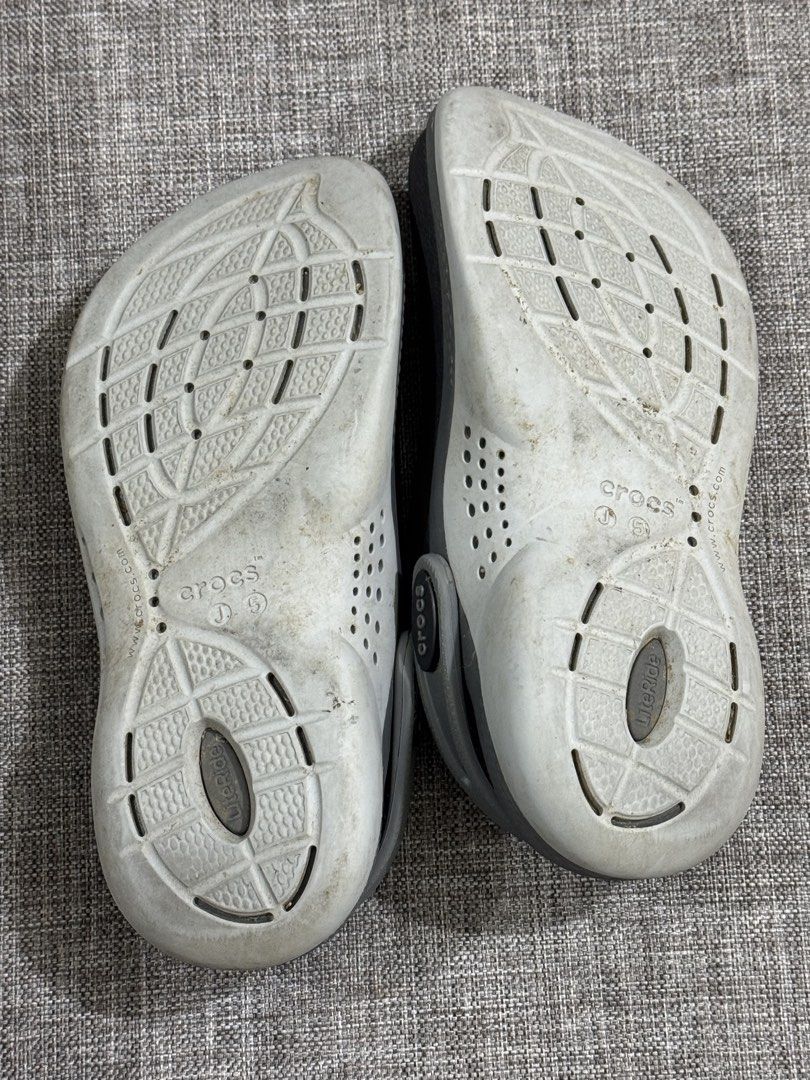 Crocs LiteRide Clogs Grey Size 5 (Category: Slippers & Slides) located in Mandaluyong City. Submitted by fidgetcracker (Listing ID 1471421154, Image 3). Description: - Item: Grey Crocs LiteRide Clogs - Size: 5 - Comfort: Super soft LiteRide foam insoles for all-day wear - Design: Perforated uppers for airflow and adjustable heel straps with Crocs branding - Condition: Pre-loved with some dirt and wear on the soles - Perfect as easy everyday slip-
