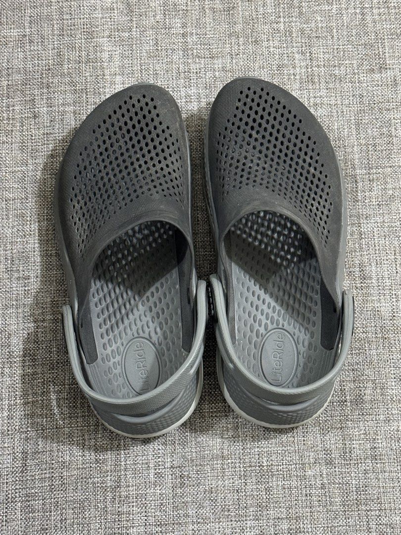 Crocs LiteRide Clogs Grey Size 5 (Category: Slippers & Slides) located in Mandaluyong City. Submitted by fidgetcracker (Listing ID 1471421154, Image 1). Description: - Item: Grey Crocs LiteRide Clogs - Size: 5 - Comfort: Super soft LiteRide foam insoles for all-day wear - Design: Perforated uppers for airflow and adjustable heel straps with Crocs branding - Condition: Pre-loved with some dirt and wear on the soles - Perfect as easy everyday slip-