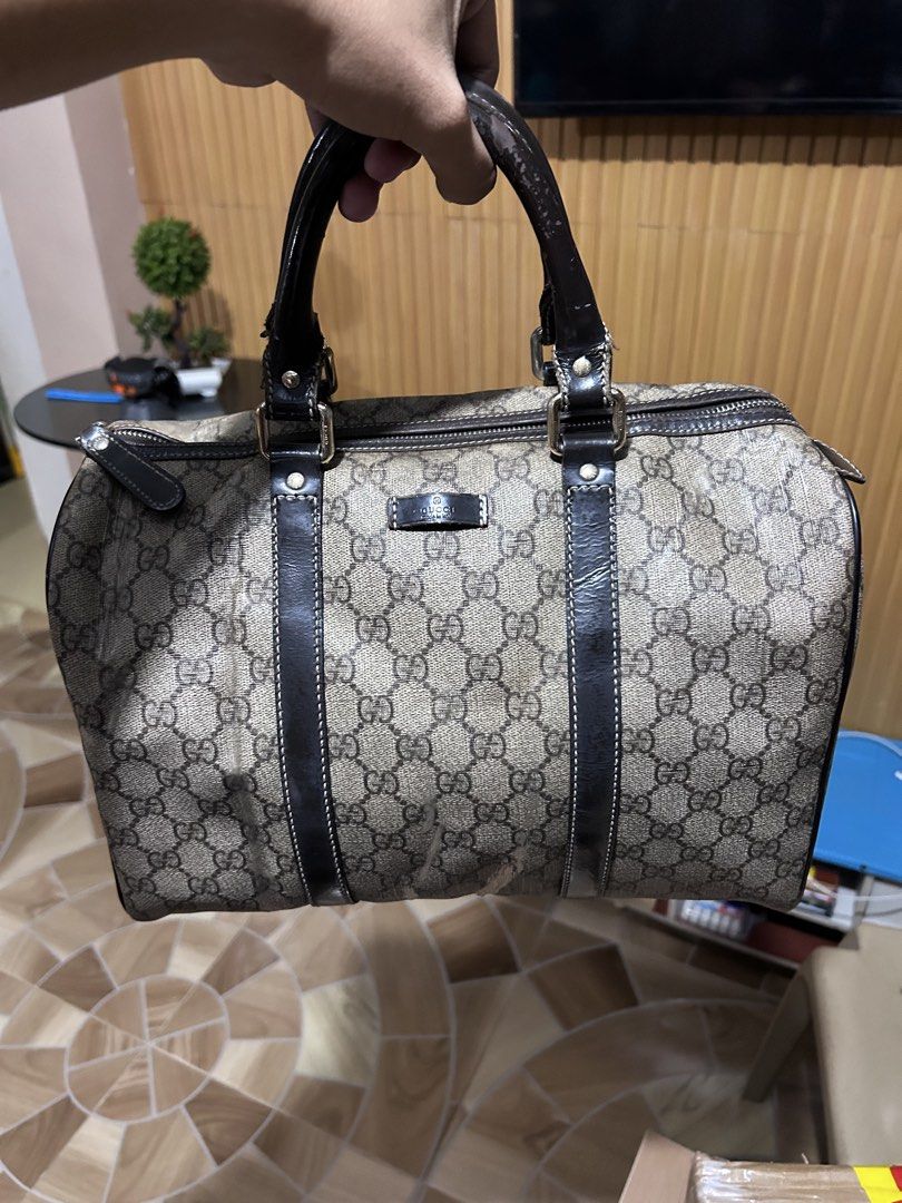 Gucci GG Supreme Boston Bag (Category: Luxury Bags & Wallets) located in Manila. Submitted by garmentfinds.01 (Listing ID 1471345484, Image 2). Description: - Authentic Gucci duffel bag in classic GG monogram canvas - Features double dark leather top handles and matching trim - Secure top zipper closure with gold hardware zipper pull - Fabric-lined interior complete with leather Gucci stamp tag - Condition: Shows some signs of wear on the canvas 