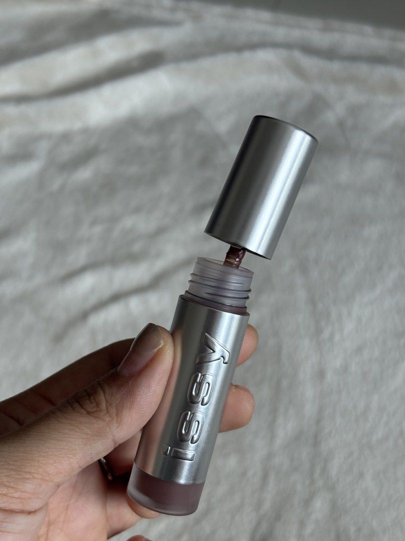 Issy Lip Moussed Tint in Teddy (Category: Makeup) located in Quezon City. Submitted by haha10_4 (Listing ID 1471343191, Image 3). Description: - Brand: Issy Hydragloss - Shade: Teddy (cool brown tone) - Size: Net weight 5ml / 0.169 fl oz - Packaging: Sleek silver with embossed logo and easy-twist cap - Perfect everyday neutral lip shade - Swatched only.