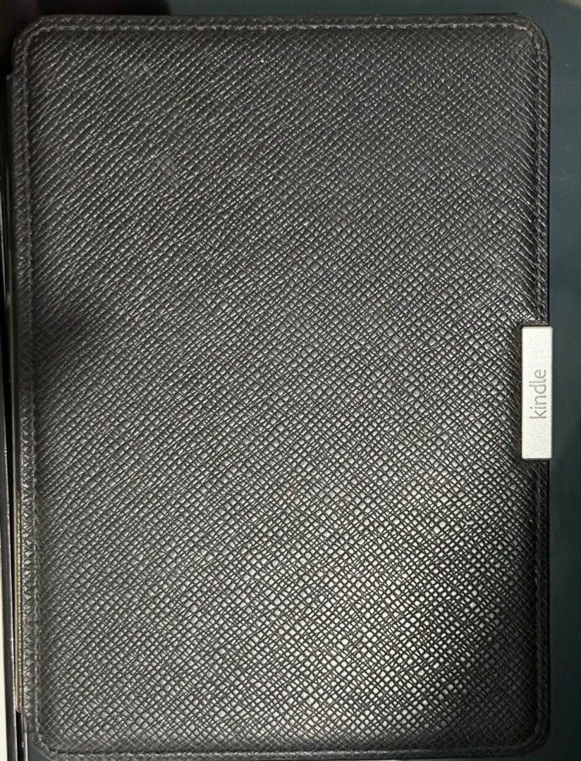 Kindle Paperwhite with case (6") (Category: E-Readers) located in Santa Rosa. Submitted by biancamarie0404 (Listing ID 1471340199, Image 1). Description: - Fully functional Amazon Kindle e-reader with a crisp touchscreen and clear e-ink text - Great battery life with a visible percentage indicator at the top right - Includes a textured black leather folio case with a secure magnetic closure tab - Adjustable font sizes and built-in store menus for