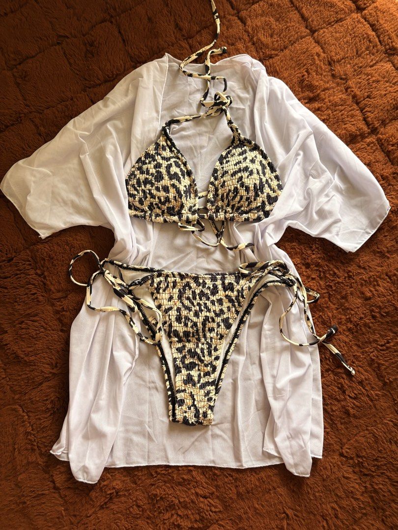 Leopard Print Bikini Set With White Cover Up (Category: Bikinis & Swimsuits) located in Makati City. Submitted by jinlouise (Listing ID 1471307965, Image 1). Description: - 3-piece set: Halter bikini top, adjustable side-tie bottoms, and a sheer white kimono cover-up - Eye-catching leopard print in a trendy crinkle texture fabric - Lightweight, short-sleeve sheer cover-up perfect for the beach or pool - Adjustable ties ensure a customizable fit -