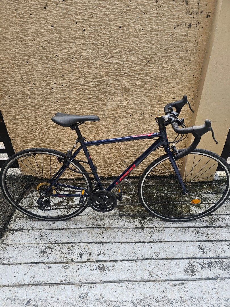 Lespo Road Bike Bicycle (Category: Bicycles) located in Paranaque City. Submitted by mfam1986 (Listing ID 1471399093, Image 1). Description: - Brand: Lespo road bike - Color: Dark blue with black saddle and wheels - Handlebars: Drop handlebars - Gearing: Shimano setup with standard multi-gear crankset - Safety: Reflectors fitted - Condition: Used with minor frame scuffs; rides fine and shifts smoothly - Best for: Daily commuting or weekend starte