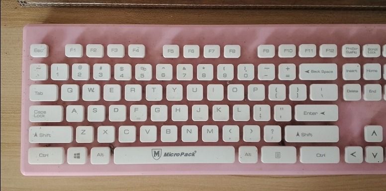 MicroPack Pink and White Mechanical Keyboard (Category: Computer Keyboard) located in Roxas City. Submitted by demalatagiboy (Listing ID 1471392146, Image 2). Description: - Brand: MicroPack - Design: Pink frame with white keycaps and full numpad (Standard QWERTY layout) - Connection: Wired - Condition: Fully functional, shows minor dust and marks around the keys from normal use - Ideal for: Typing, work, or gaming desk setups.