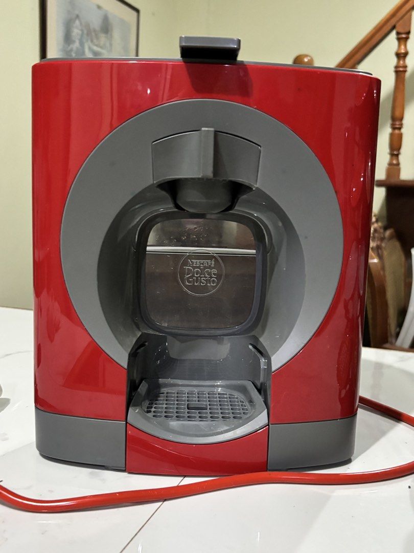 Nescafe Dolce Gusto Coffee Machine Bundle with Capsule Holder and Pods (Category: Coffee Machines & Makers) located in Manila. Submitted by beaaa.4 (Listing ID 1471429029, Image 2). Description: - Red and grey Nescafe Dolce Gusto capsule coffee machine - Includes a black revolving capsule stand - Comes with opened boxes of Flat White and Cafe Au Lait pods - Plugged in and ready to use - Great home coffee setup, selling as I'm clearing out kitchen