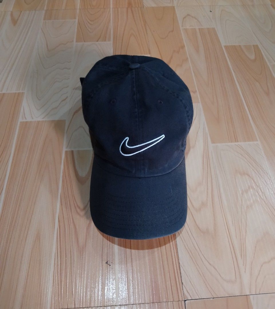 Nike Heritage86 Black Cotton Baseball Cap (Category: Caps & Hats) located in San Jose del Monte. Submitted by azetor (Listing ID 1471310870, Image 1). Description: - Brand: Nike Heritage86 - Color: Classic Black - Material: 100% cotton body and lining for breathable comfort - Design: Unstructured dad hat shape with white embroidered Swoosh logo - Closure: Adjustable strap with metal slider buckle and small Swoosh detail - color rate 9/10 - great 