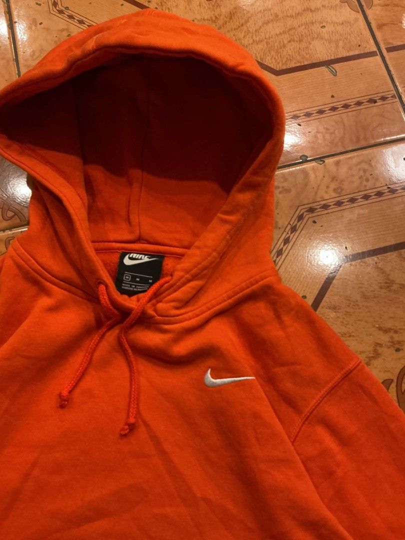 Nike Orange Hoodie Pullover Sweatshirt Size M (Category: Coats, Jackets and Outerwear) located in Manila. Submitted by cualesdyla42584 (Listing ID 1471398999, Image 2). Description: - Brand: Nike - Color: Bright Orange with embroidered white swoosh - Size: Medium (Style code: BV4119-891) - Material: Soft fleece interior, warm and cozy - Features: Classic drawstring hood, front pouch pocket, ribbed cuffs and hem - Condition: Excellent, shapes hold