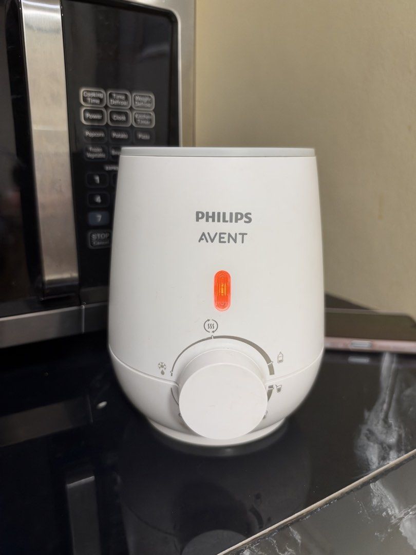 Philips Avent Fast Baby Bottle Warmer SCF355 (Category: Breastfeeding & Bottle Feeding) located in Pasig City. Submitted by athriftrack (Listing ID 1471314722, Image 1). Description: - Condition: Powers up, red indicator light working, clean inside heating basket - Features: Adjustable dial for defrosting and warming milk or baby food - Inclusions: Comes with original manual and box.