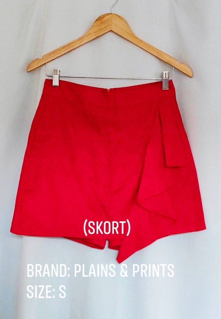 Plains & Prints Red Skort Size S (Category: Skirts) located in Bacoor. Submitted by stargazer1084 (Listing ID 1471354233, Image 1). Description: - Brand: Plains & Prints - Size: S - Color: Bright red - Design: Skort (skirt front, shorts back) with an asymmetric flap - Closure: Back zip - Condition: Clean fabric, vibrant color - Styling: Perfect to match with basic tops for casual or smart-casual outings.
