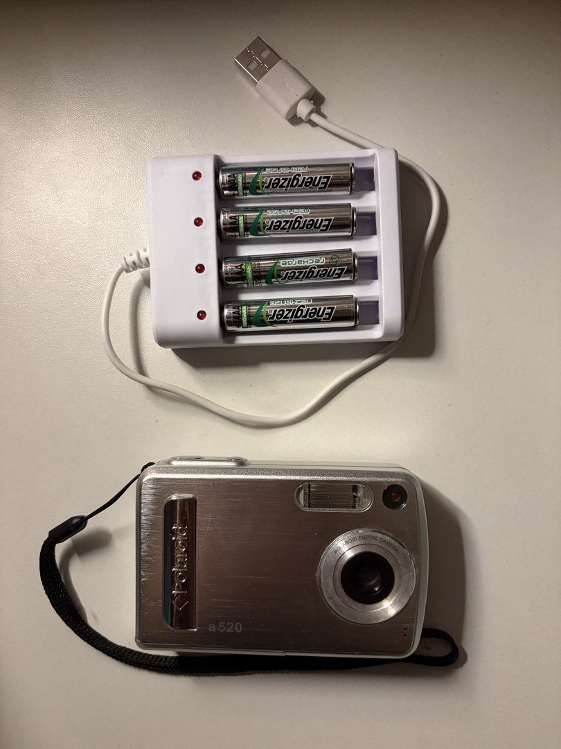 Polaroid a520 Digital Camera (Category: Cameras) located in Imus. Submitted by jpgworks (Listing ID 1471418093, Image 2). Description: - Polaroid a520 digital camera in silver - Fully tested and working (screen displays settings clearly) - Produces aesthetic vintage-style early digital photos - Compact and lightweight, perfect for everyday carry - Ready to use: includes 4 Energizer rechargeable batteries and a USB charging dock - Comes with an at