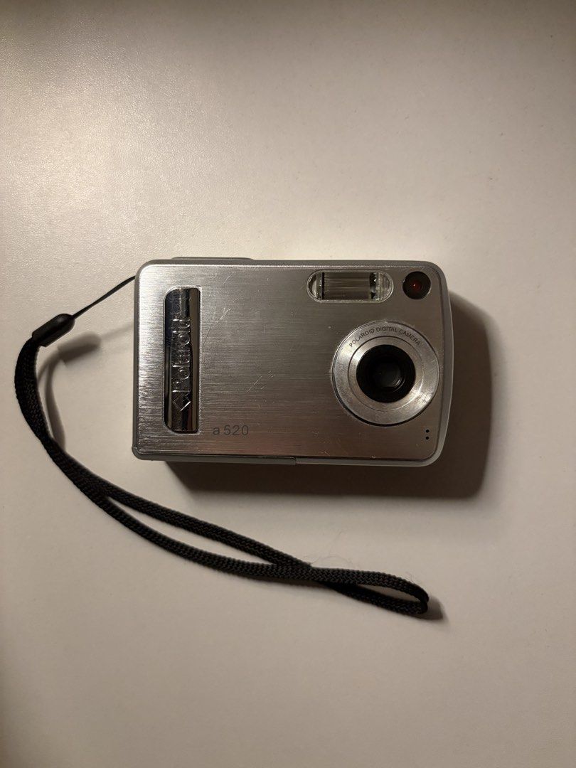 Polaroid a520 Digital Camera (Category: Cameras) located in Imus. Submitted by jpgworks (Listing ID 1471418093, Image 1). Description: - Polaroid a520 digital camera in silver - Fully tested and working (screen displays settings clearly) - Produces aesthetic vintage-style early digital photos - Compact and lightweight, perfect for everyday carry - Ready to use: includes 4 Energizer rechargeable batteries and a USB charging dock - Comes with an at
