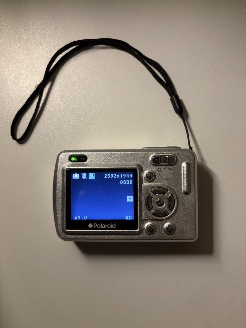 Polaroid a520 Digital Camera (Category: Cameras) located in Imus. Submitted by jpgworks (Listing ID 1471418093, Image 3). Description: - Polaroid a520 digital camera in silver - Fully tested and working (screen displays settings clearly) - Produces aesthetic vintage-style early digital photos - Compact and lightweight, perfect for everyday carry - Ready to use: includes 4 Energizer rechargeable batteries and a USB charging dock - Comes with an at