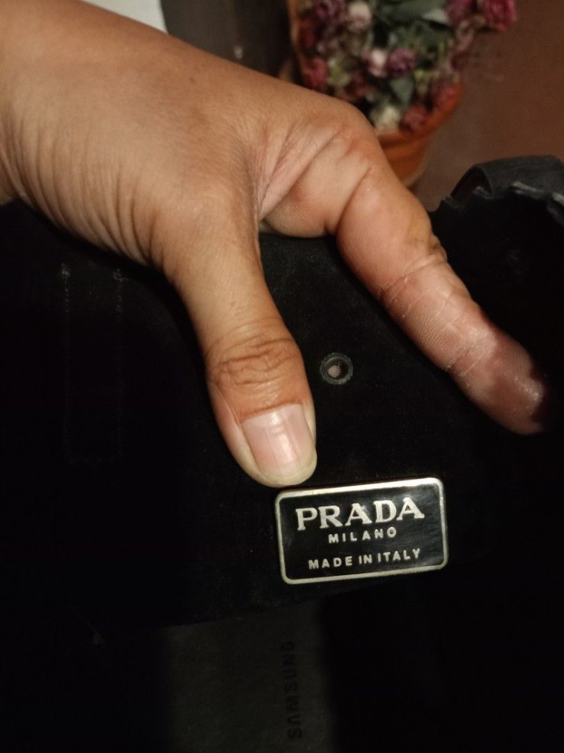 Prada Black Leather Shoulder Bag (Category: Luxury Bags & Wallets) located in Quezon City. Submitted by cher_jayanne (Listing ID 1471416646, Image 2). Description: - Brand: Prada - Style: Classic curved hobo shoulder bag - Material: Premium black leather - Hardware: Silver-tone with branded metal links - Closure: Secure snap closure - Interior: Clean lining, metal logo plaque, and tag numbered 175 - Condition: Excellent, clean inside and out - Au