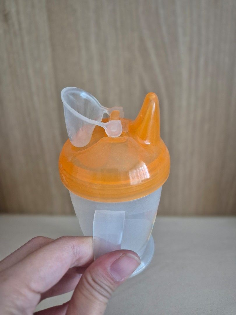 PUR baby training sippy cup with handles (Category: Weaning & Toddler Feeding) located in San Juan City. Submitted by apetitegirl (Listing ID 1471412274, Image 2). Description: - Brand: PUR - Color: Translucent white and orange with cute fox and bunny graphics - Double handle design for easy independent holding by little hands - Spout lid with protective cover to keep the mouthpiece clean - Easy to take apart for thorough, hassle-free cleaning - 