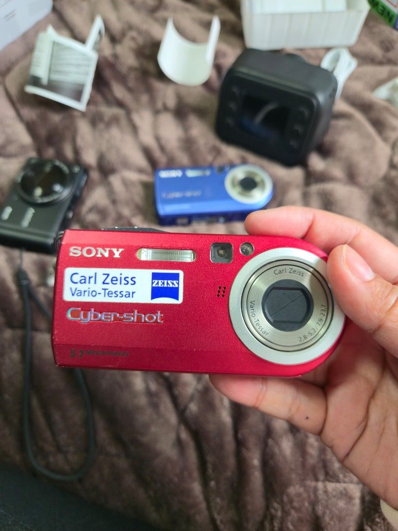 Sony Cyber-shot DSC-P100 Red Digital Camera (Category: Cameras) located in Malvar. Submitted by jobellicious (Listing ID 1471310539, Image 2). Description: JAPAN PASABUY ETA DEC 18TH 100% Working - Model: Sony Cyber-shot DSC-P100 - Color: Striking Red - Resolution: 5.1 Megapixels - Optics: Carl Zeiss Vario-Tessar lens - Condition: Powers up fine, compact retro point-and-shoot body - Inclusions: Hand strap attached - Storage: Uses standard memory 