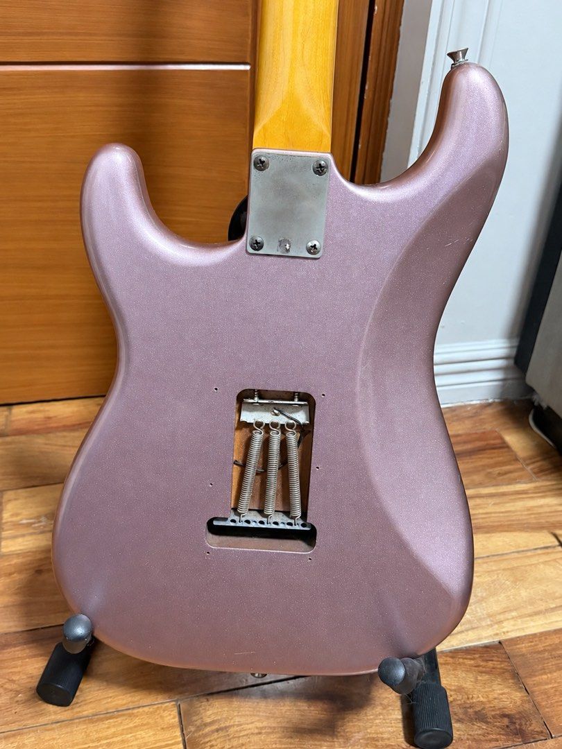 Squier Stratocaster Electric Guitar Metallic Pink (Category: Musical Instruments) located in Angeles City. Submitted by iicmat (Listing ID 1471302189, Image 2). Description: FOR SALE: Squier Classic Vibe ’60s Stratocaster – Burgundy Mist • Burgundy Mist finish with matching headstock • Gotoh tuners, bridge saddles, and pickup covers • Comes with hard case • Has visible scratches and signs of use—see photos for condition 📍 Las Piñas / BF Homes 💰