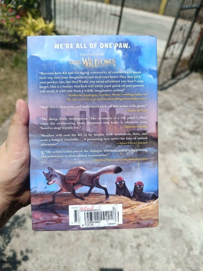 The Wild Ones book novel (Category: Storybooks) located in Tumauini. Submitted by qeynichi (Listing ID 1471425834, Image 2). Description: - Title: The Wild Ones by K.C. Held - Genre: Animal adventure story starring Kit the raccoon and friends - Format: Paperback featuring a map illustration on the front inner pages - Price Tag: National Bookstore tag of 175 pesos still attached on the back cover - Condition: Pages show natural yellowing from age,