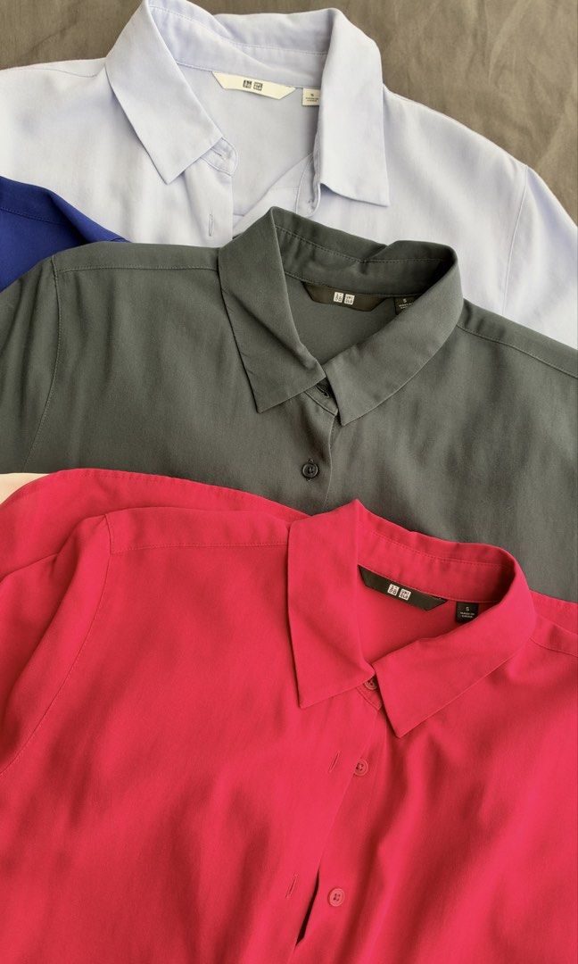 Uniqlo Rayon Blouse Short Sleeve (Category: Blouses) located in Taguig. Submitted by peanutbutterlove (Listing ID 1471360228, Image 3). Description: - Brand: Uniqlo - Size: Small (S) - Colors: Royal blue, light blue, dark grey, light pink, magenta pink - Design: Classic button-down collar with short sleeves - Fabric: Smooth, lightweight, and drapes nicely - Condition: Clean and well-kept Store SRP: P1,290 ‼️ buy all 5 for only P1,500 ⚠️ Price if 