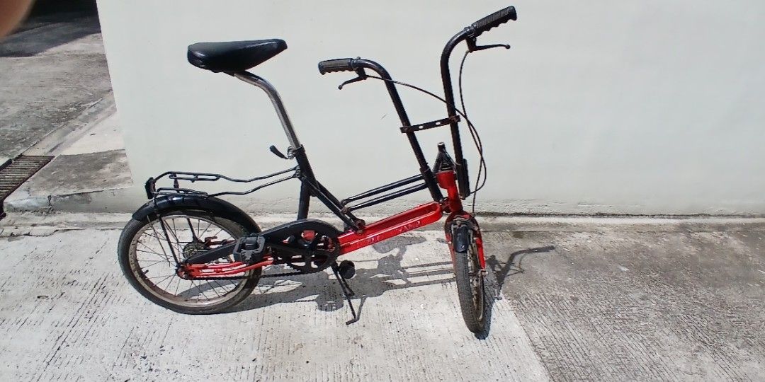 Vintage scooma folding bike (Category: Bicycles) located in Marikina City. Submitted by darthvader888 (Listing ID 1471155139, Image 2). Description: - Brand: Field Champ folding bicycle - Color: Striking Red and Black - Features: Compact small-wheel design, convenient rear rack, and sturdy kickstand - Portability: Handlebars fold down easily for compact storage and transport - Mechanical: Chain and gears are intact and fully functional.