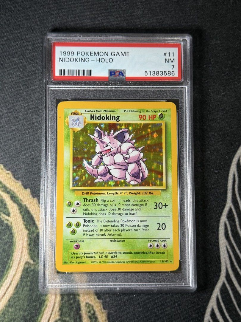 1999 Pokémon Base Set Nidoking Holo #11 — PSA 7 (Category: Graded Singles) located in Cavite. Submitted by shakir16_ (Listing ID 1465894284, Image 1). Description: 🦏 1999 Pokémon Base Set Nidoking Holo #11 — PSA 7 • 1999 Pokémon Base Set • Nidoking Holo #11/102 • PSA 7 NM • English / Unlimited • PSA graded & encapsulated • Original WOTC-era Pokémon Negotiable for serious buyers. 📦 Shipping available 🤝 Meetup possible #Pokemon #Nidoking #BaseSe