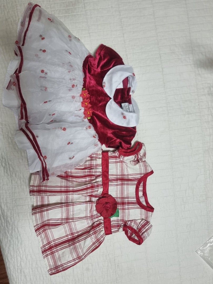 2 Pack Baby Girl Dresses (Category: Babies & Kids Fashion) located in Narvacan. Submitted by 2ndchancefinder (Listing ID 1465906534, Image 1). Description: - Bundle of 2 festive holiday dresses for baby girls (Size: 0-3 months) - Dress 1: Youngla red velvet dress featuring a white collar and fluffy mesh skirt - Dress 2: George red & white plaid dress with an adorable fabric flower at the waist - Made with soft, baby-friendly fabrics that are easy